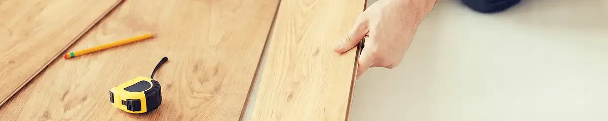 A professional installing wood flooring in Jackson, MS