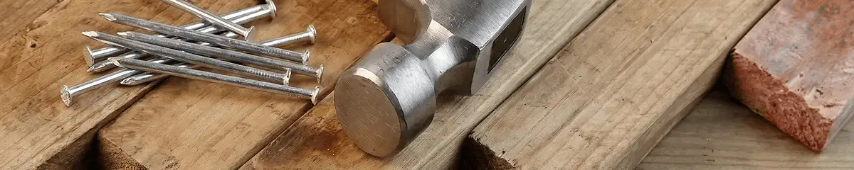 Hammer and nails on hardwood flooring boards in Jackson, MS
