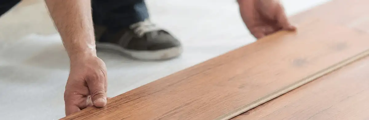 A professional installing laminate flooring in Jackson, MS