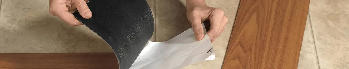 A professional installing vinyl flooring in Jackson, MS