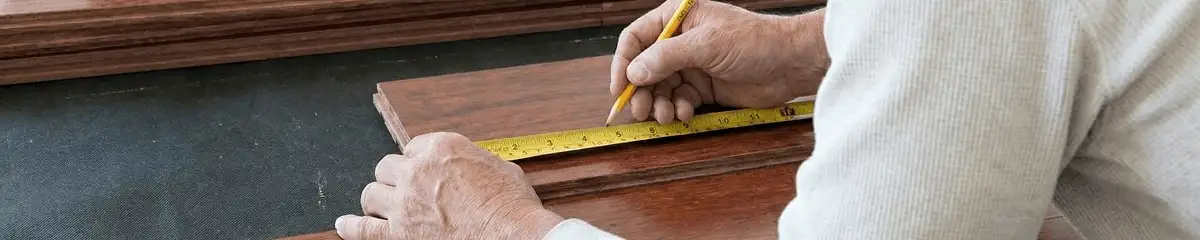 A professional installing wood flooring in Jackson, MS